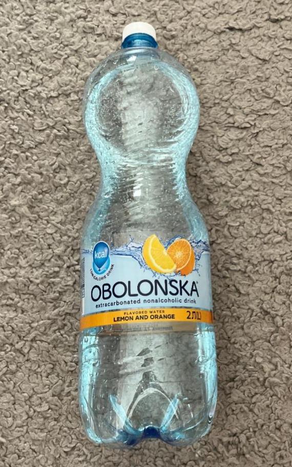 Фото - Напиток безалкогольный сильногазированный со вкусом лимона и апельсина Оболонська
